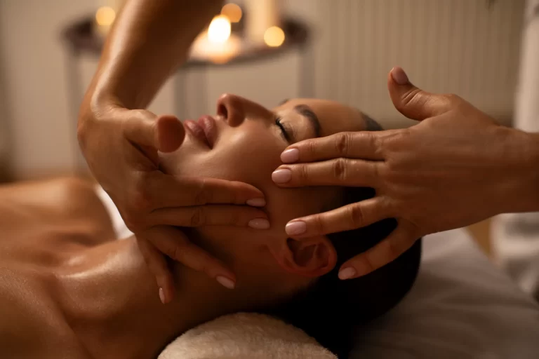 masseuse-giving-woman-face-massage-calm-relaxing-atmosphere-relaxed-woman-lying-couch-with